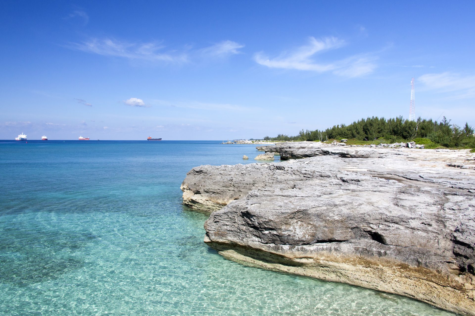 Clear, shallow water lapping at a limestone shoreline on Grand Bahama
