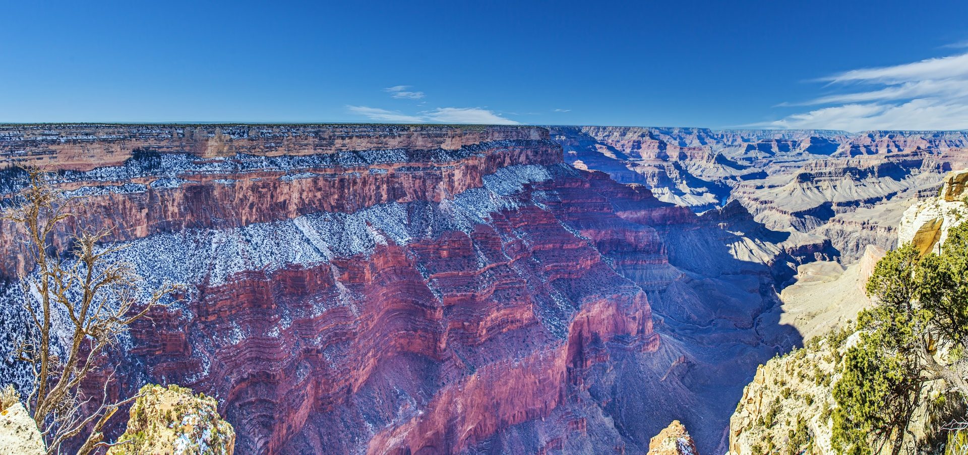 A panoramic view of the layered red rock walls of the Grand Canyon