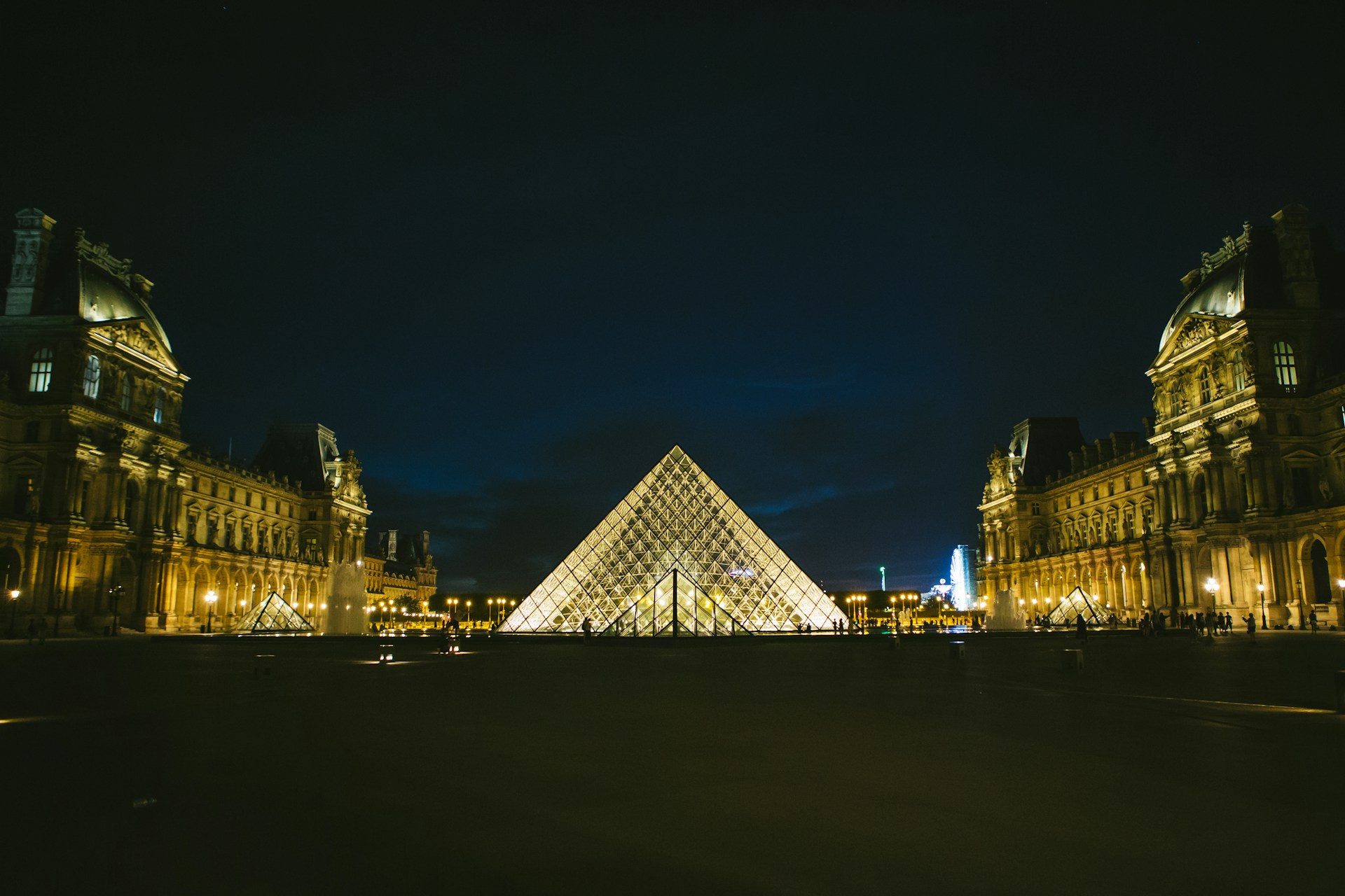 The glass pyramid at the Louvre lit up at night