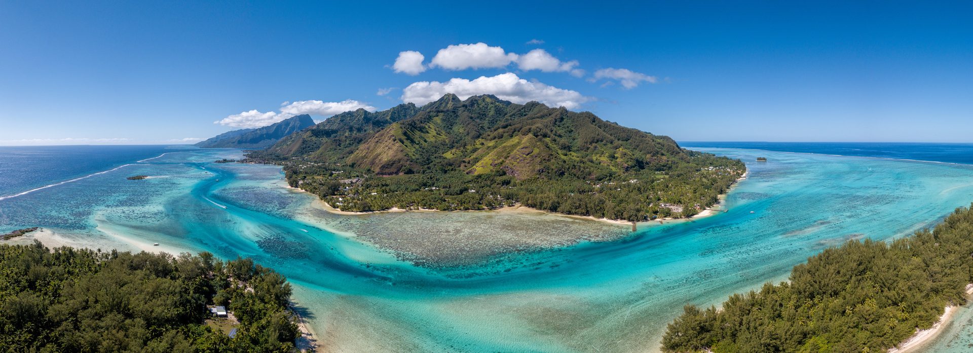 Aerial view of the blue lagoon and green peaks of Moorea