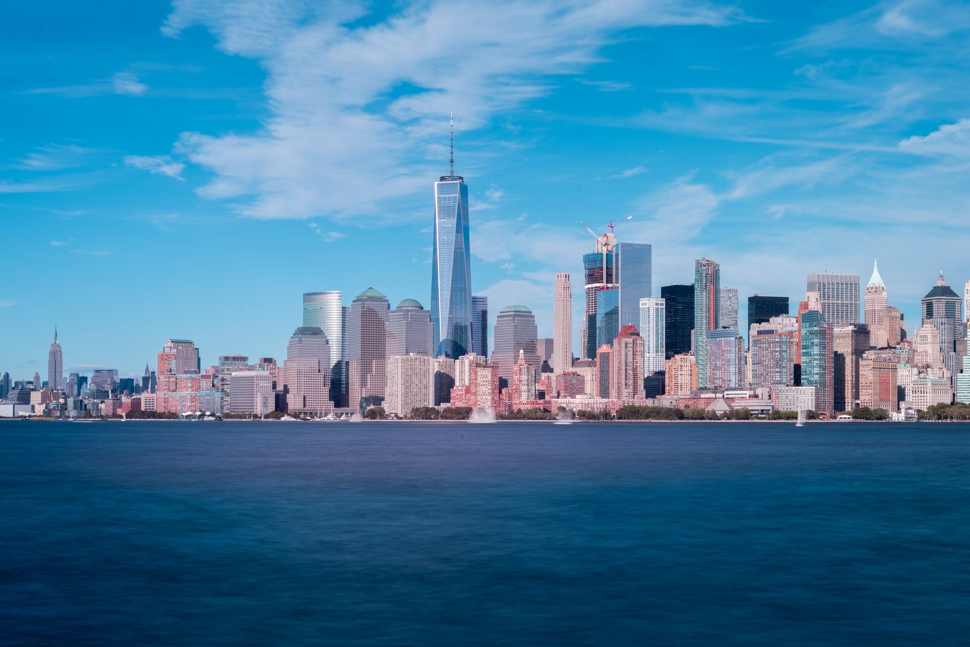 The New York City skyline across the water on a clear summer day