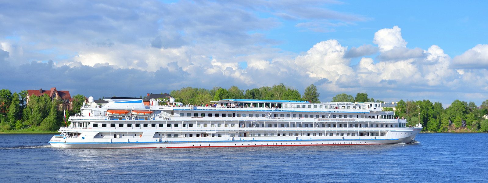 A long, low river cruise ship on a European river