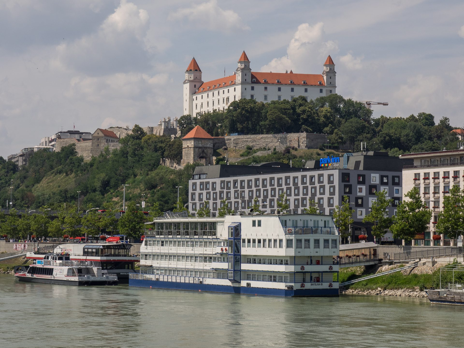 River cruise ships docked on the Danube in Bratislava below the castle